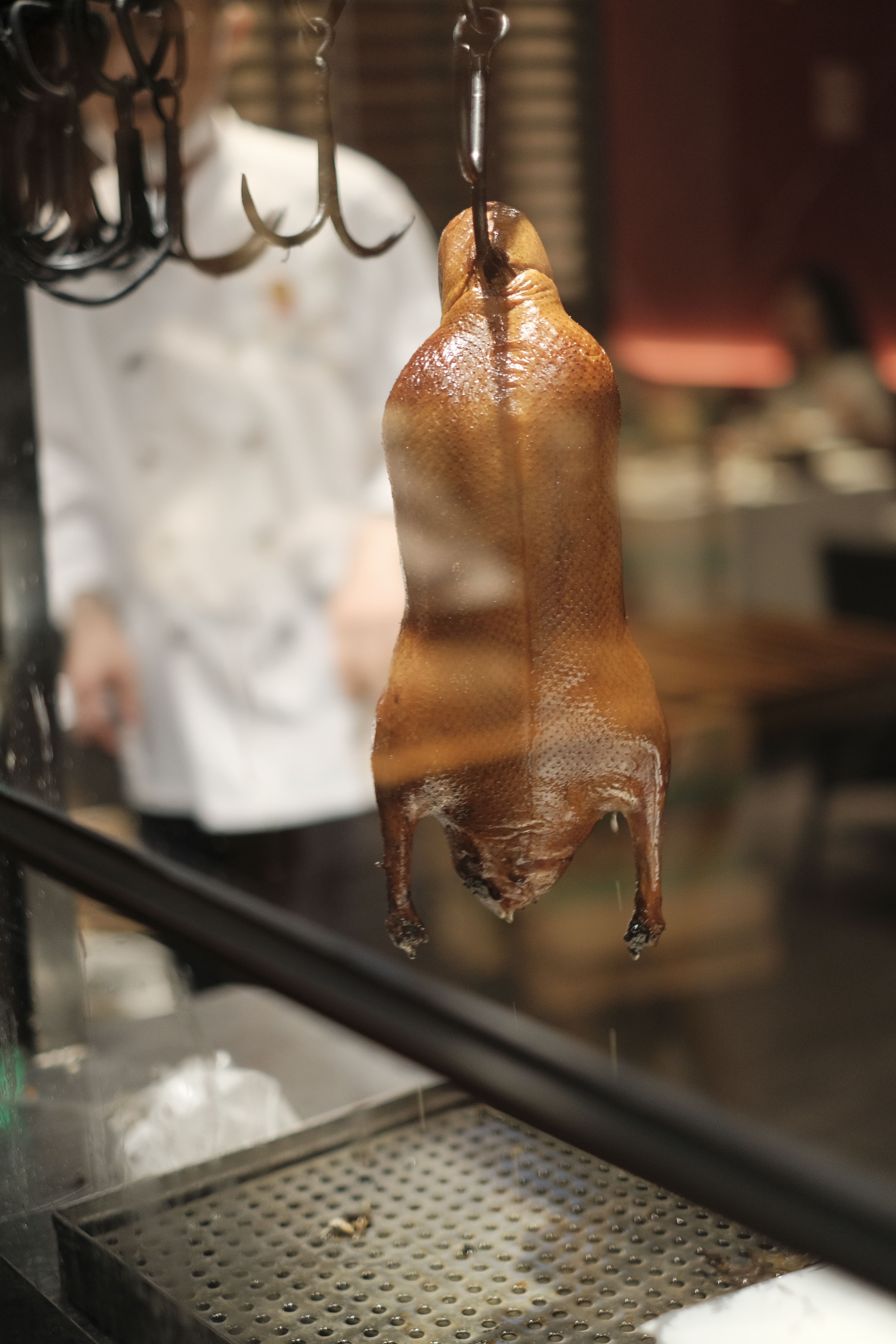 After cooking, the ducks hang to rest