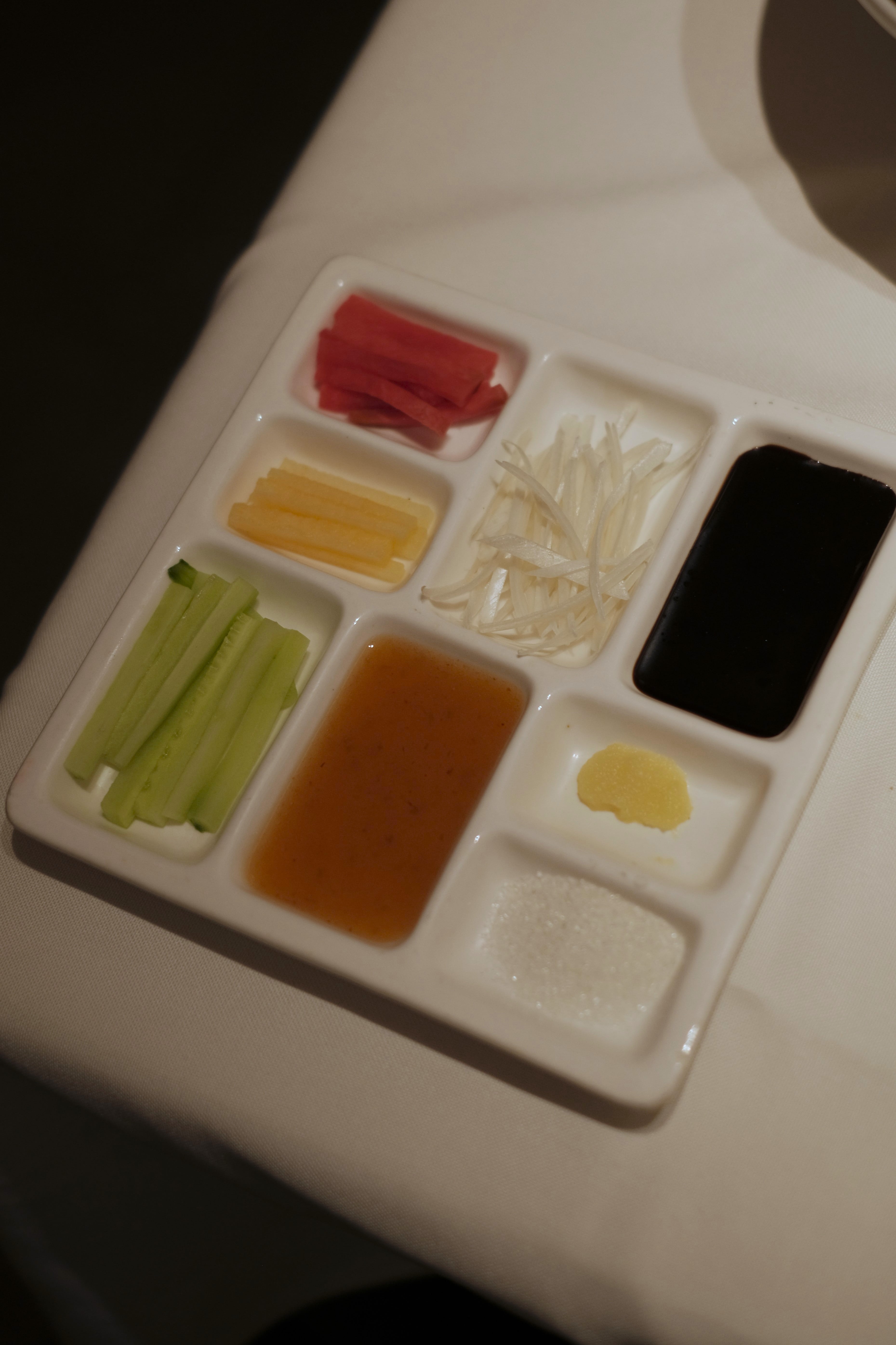 Condiments include pickled vegetables, cucumber, plum sauce, and sugar to name a few.